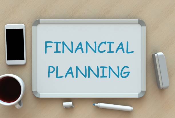 istock Financial Planning, message on whiteboard, smart phone and coffee on table 671605220