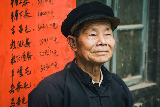 Chinese Senior Man Chengyang China Real People Portrait Chinese senior man looking confident standing outside of small village store. Chinese Real People Portrait. Chengyang, Sanjiang, Guizhou, China. Unretouched Hand written copyright free background. mao original stock pictures, royalty-free photos & images