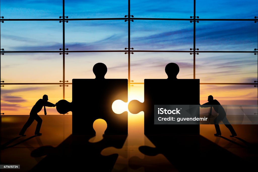 Business teamwork - puzzle pieces Mergers and Acquisitions Stock Photo