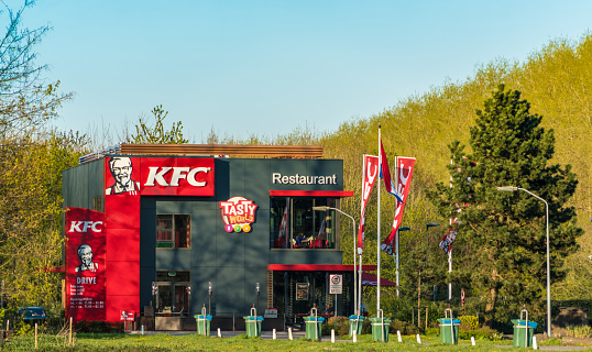 Lelystad, The Netherlands, April 18, 2017: Custumors eating and driving by the Drive Through KFC in Lelystad next to the Highway A6