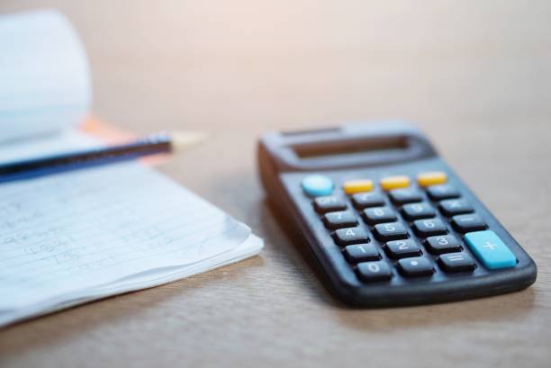 istock calculator, a notebook and a pencil on a table, tax season concept 671623688