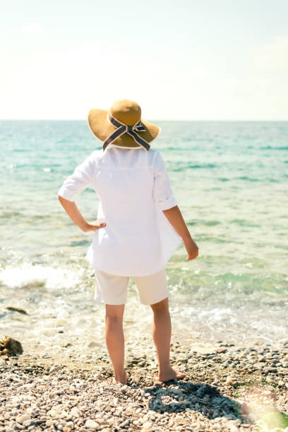istock Woman staring at the sea 671637812