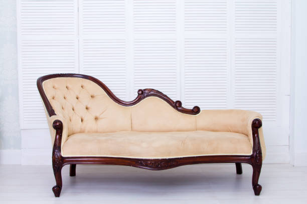 istock Beige textile classical style sofa in vintage room 671640356