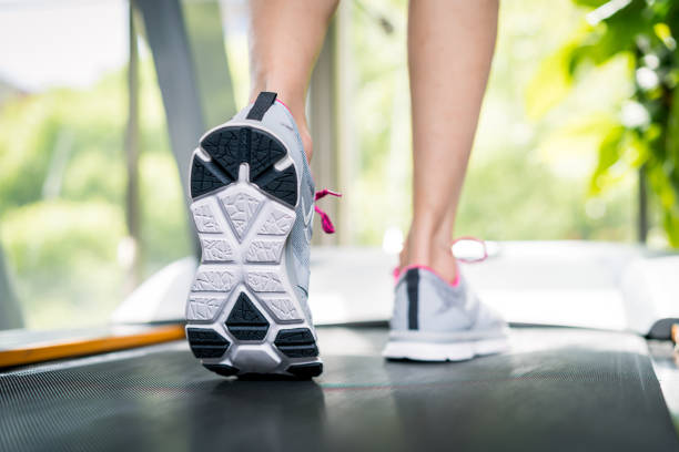istock Girl running on treadmills in a gym 671640894