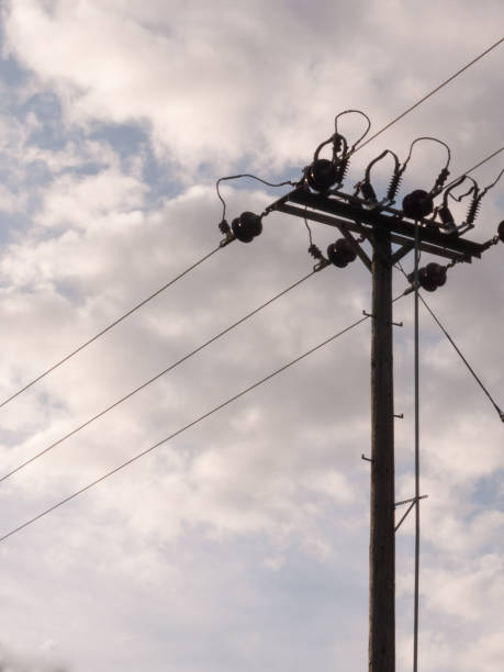 istock an overhead electrical wire post with metal wires running to and from with a cloudy background isolated closeup detail 671641084