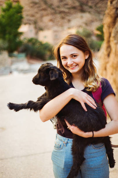 istock Woman holding little goat 671641124