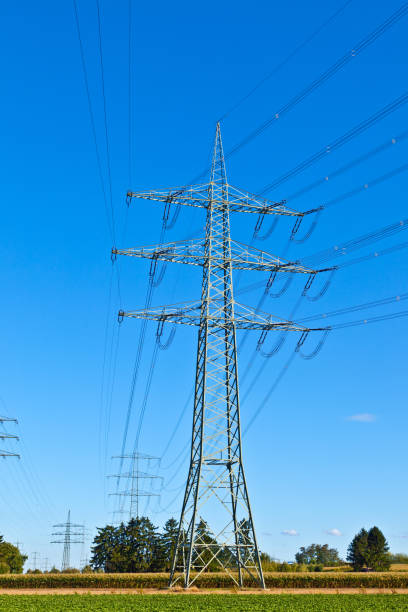 istock Steel electricity pylon on bright blue sky 671641496