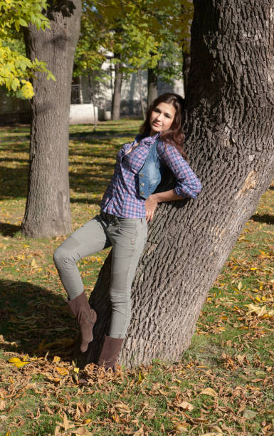 istock The girl at a tree 671643772