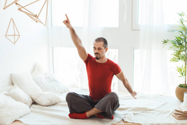 istock Man in a yoga pose does gymnastics. 671644428