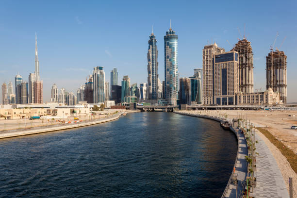 Low-angle view of skyscrapers and modern buildings by the waterfront in Dubai city centre, United Arab Emirates