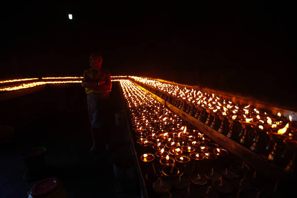 istock Many candle flames glowing in the dark 671648808