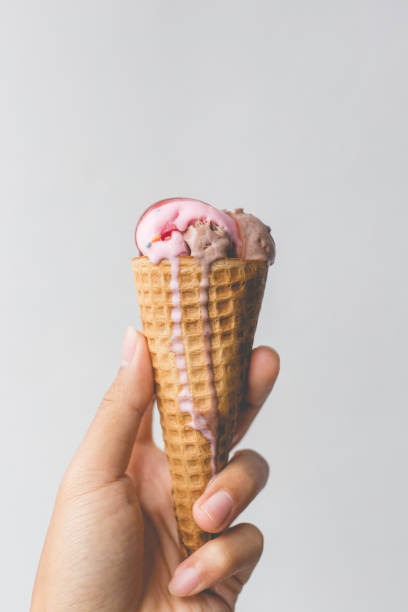 istock Man's hand holding Ice cream melting in the summer day. 671649882