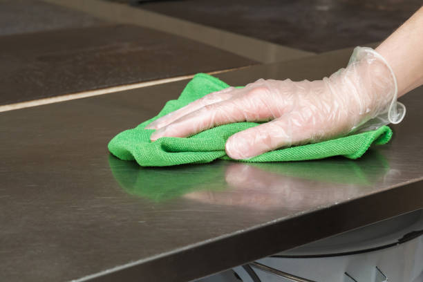 istock Hand in protective glove with rag cleaning kitchen equipment in the professional kitchen. Stainless steel surface. Early spring cleaning or regular clean up. 671652732