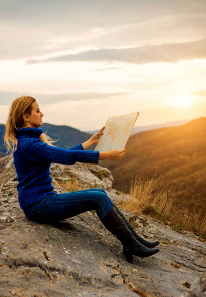 istock Young woman pointing the way 671656866
