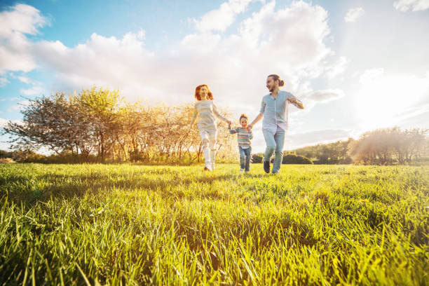 istock Happy family running in the park 671657064