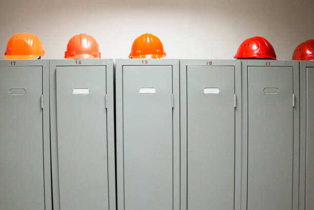 istock Metal lockers and plastic hard hats 671660262