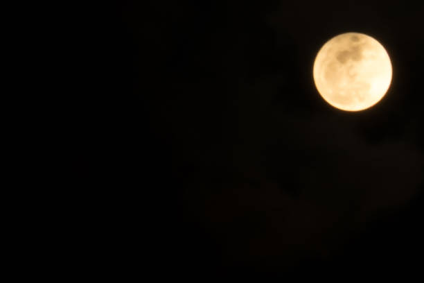 istock Supermoon: Orange glowing full moon in dark sky 671663334