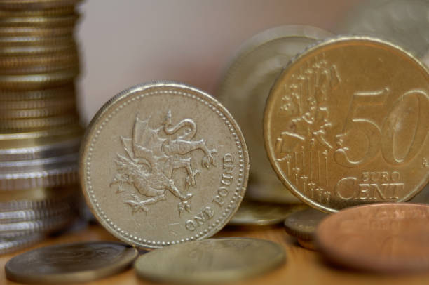 istock 50 eurocent and one pound coins on the table 671664284