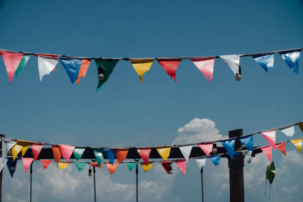 istock Colorful flags bunting against blue sky 671664388