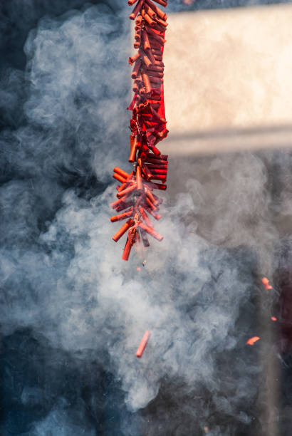 Exploding Chinese Firecrackers with Much Smoke Exploding Chinese Firecrackers with Much Smoke firework explosive material photos stock pictures, royalty-free photos & images