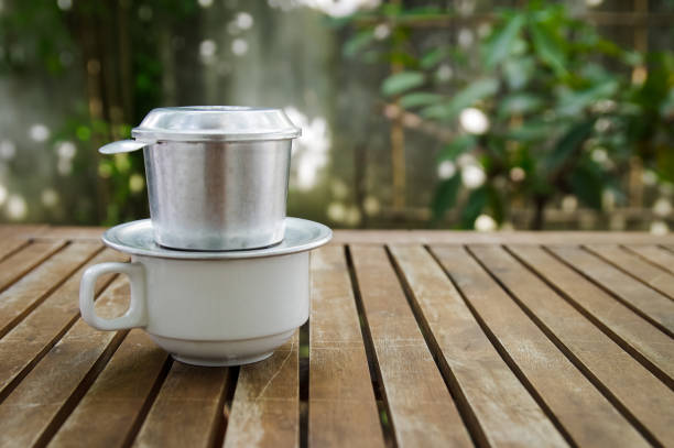 istock A cup of coffee with spool & filter above on a wooden table 671667746