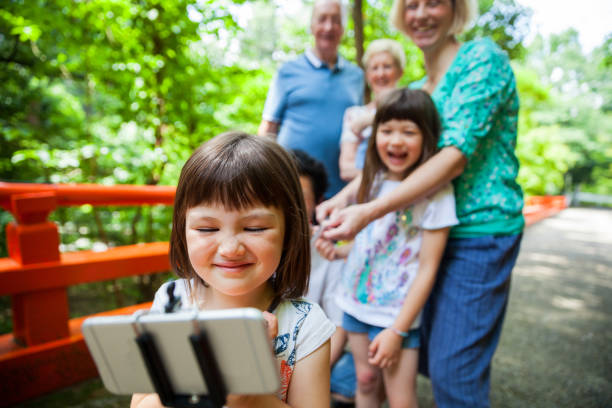 istock Mixed japanese family selfie time 671674000