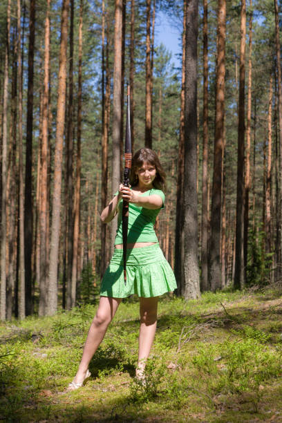 young girl archery in a summer forest