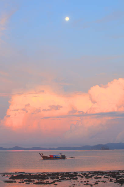 long boat and rocks on beach in Krabi, Thailand