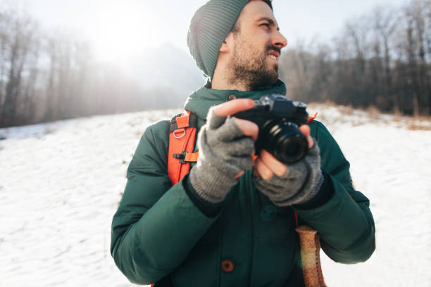 istock Young hiker photographing winter landscape 671677824