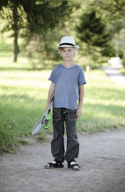 istock Kid with skateboard outdoors 671681970
