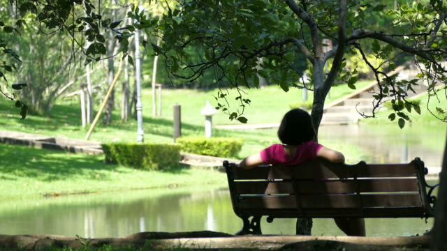 Woman sitting alone in garden