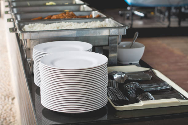 istock Set of white dishes and spoon on table for background 671695940