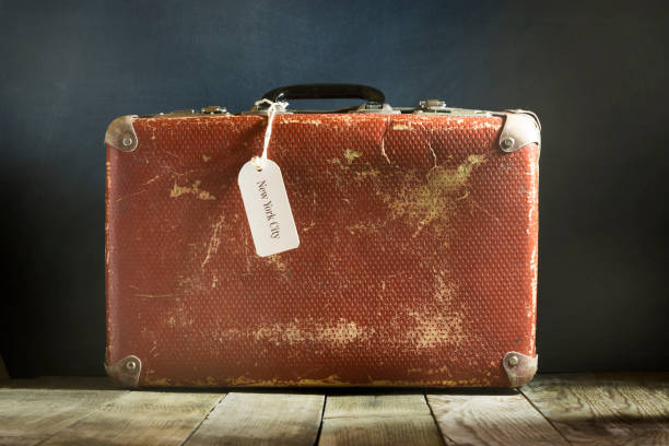 istock Old vintage suitcase on a wooden floor. 671696450