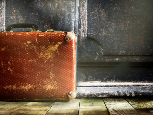 istock Old vintage suitcase on a wooden floor. 671698946