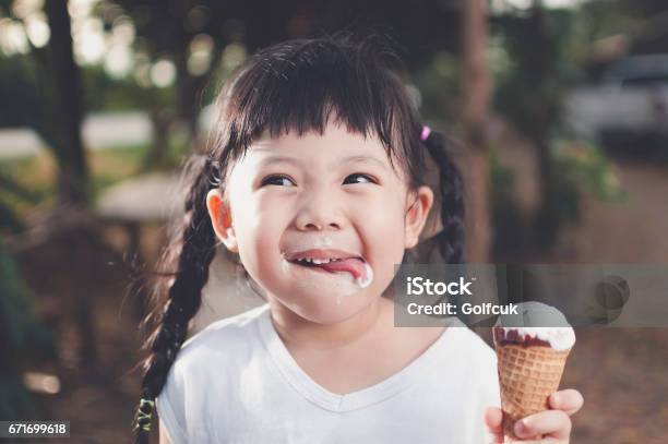 Asia Girl Eating Ice Cream Stock Photo - Download Image Now - Ice Cream, Child, Eating