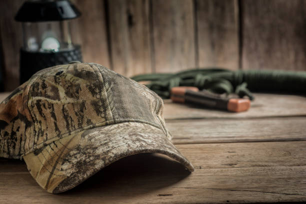 istock Hunting Hat and Hiking Equipment on Wooden table. 671699620