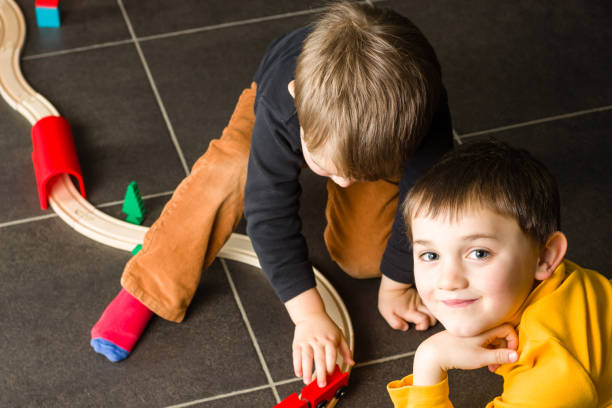 istock Kids (boys) playing with wooden trains 671710044
