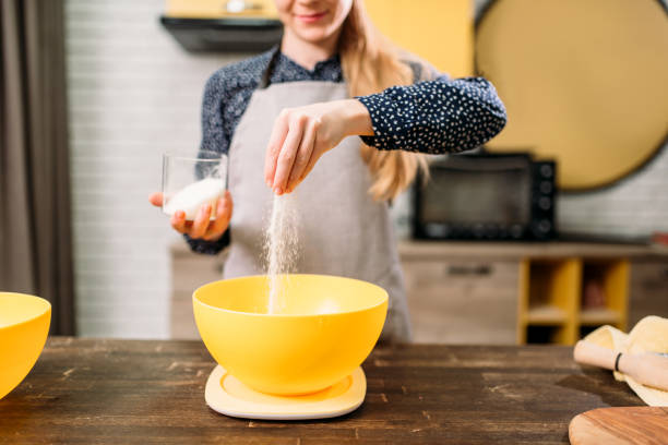 istock Female person adds sugar into  bowl, cake cooking 671710062