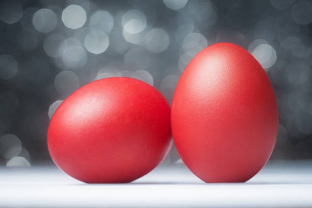 istock Close up of red painted Easter eggs over abstract background 671716808