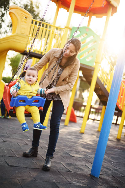istock Mother and baby boy having fun in a park 671717260