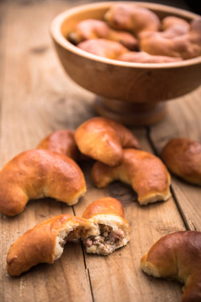 istock Homemade bacon pasties in a bowl and on table 671734736