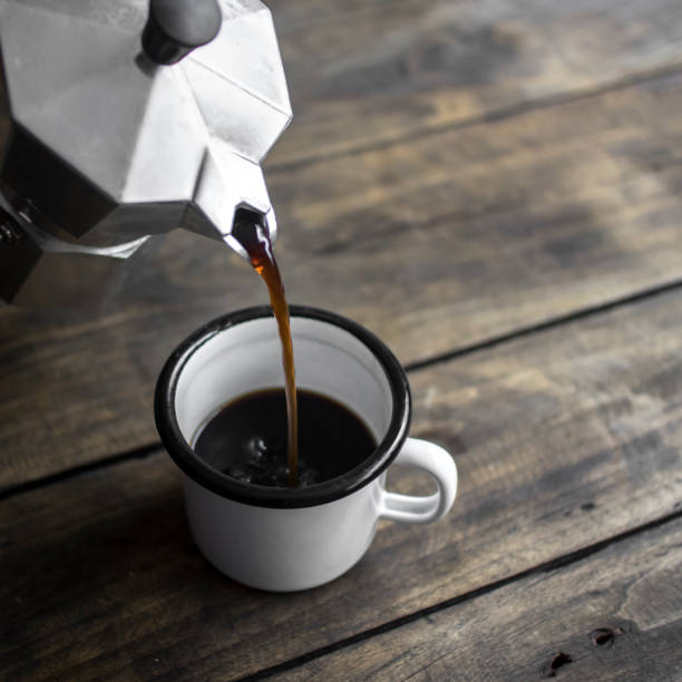 istock Pouring black coffee in the cup 671737764