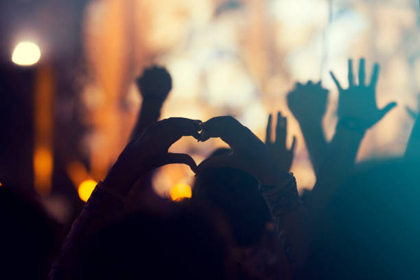 istock crowd, happy people enjoying rock concert, raised up hands 671738116