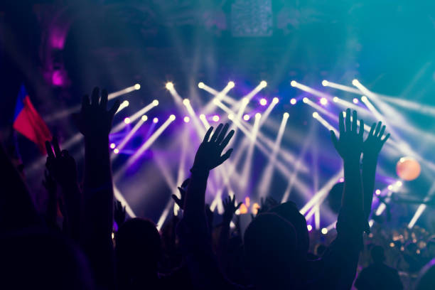 istock crowd, happy people enjoying rock concert, raised up hands 671738124