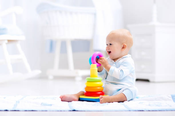 istock Baby playing with toy pyramid. Kids play 671740552