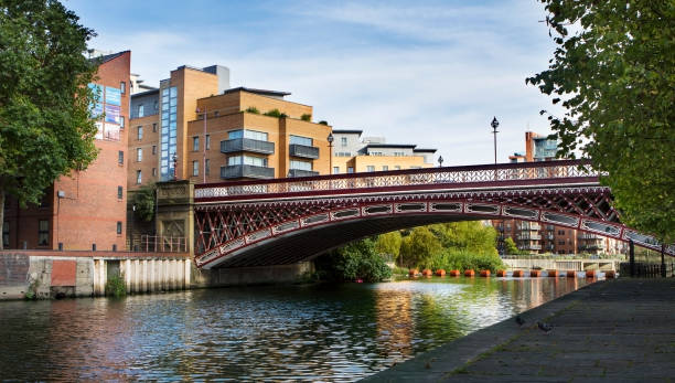 istock Red wrought iron bridge over Leeds City canal 671741144