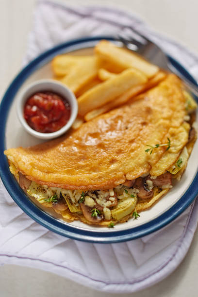 istock Omelette with mushroom, artichoke and fries 671741468