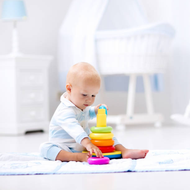 istock Baby playing with toy pyramid. Kids play 671747198