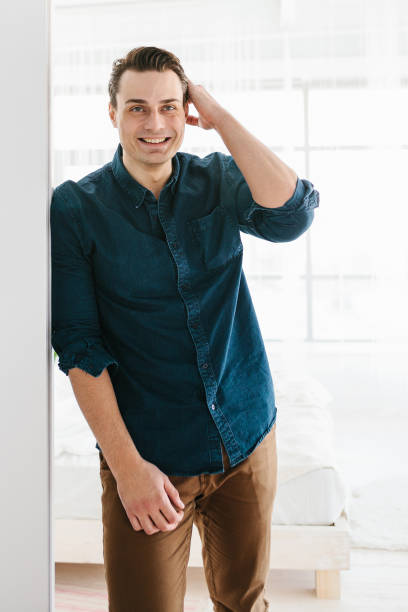 istock A handsome brutal strong man stands and smiles. 671747796