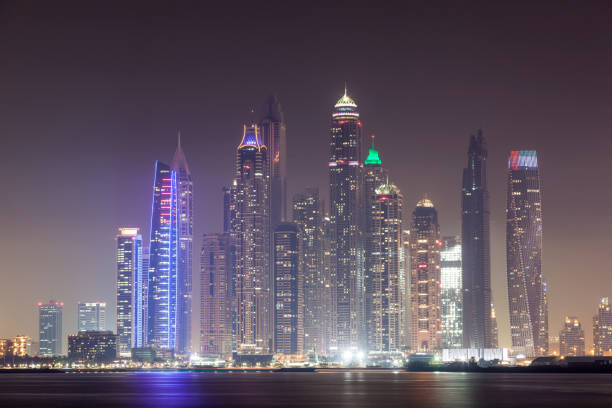 istock Dubai Marina skyscrapers at night 671750472